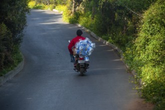 Istanbul, Turkey. 18th April 2016 A man riding a motorcycle with empty plastic water bottles on the