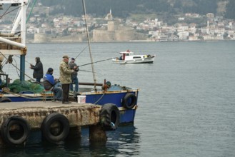 Canakkale, Turkey. 18th February 2022 Turkish fishermen on the pier overlooking the Dardanelles