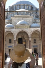 A foreign tourist enters the Suleymaniye Camii, an Ottoman imperial Mosque over looking Istanbul
