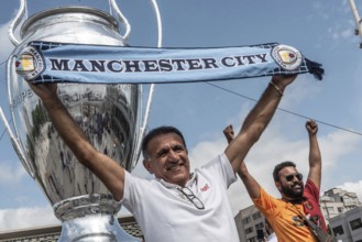 Istanbul, Turkey. June 9th 2023 A Manchester City football fan poses with a scarf in Taksim Square