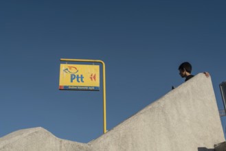 Istanbul, Turkey. October 3rd 2021 Bright Yellow PTT sign, the Turkish Post Office against a deep