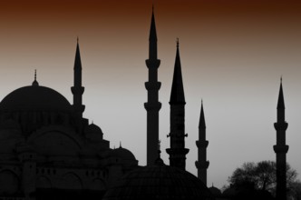 Turkish Istanbul Islamic architecture of domes and minarets silhouetted at night, an iconic