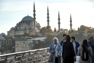 Istanbul, Turkey. November 14th 2023 Commuters leave Halic Metro station with the minarets of