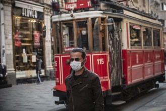 Istanbul, Turkey. November 28th 2020 A man wearing a surgical face mask along Istiklal Street,