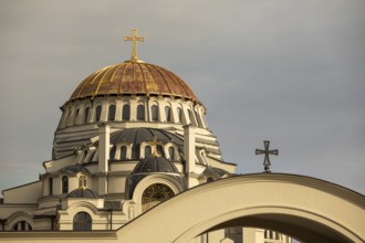 The image showcases a stunning golden dome of an orthodox church against a cloudy sky in Georgia