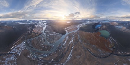 A breathtaking aerial view of Iceland's Highlands at sunrise, showcasing meandering rivers,