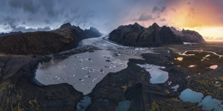 Panoramic view of Vatnajokull National Park at sunset, showcasing majestic glaciers, rugged