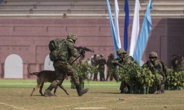 A sniffer dog accompanies personnel of the Central Reserve Police Force during a simulated