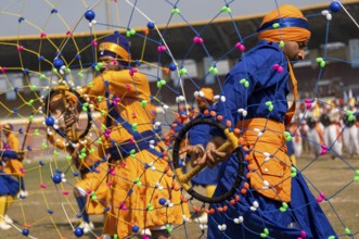 Performers in traditional attire presents a Gatka martial arts display during the 87th Raising Day