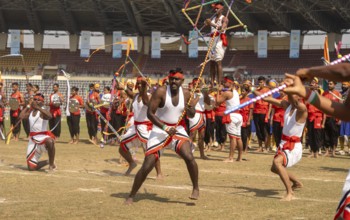 Performers stage a traditional martial arts display with swords and synchronised movements during