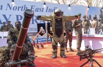 CRPF personnel display a bomb disposal suit and various weapons during a public exhibition at the