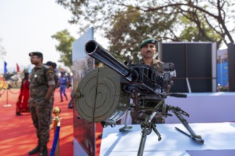 A heavy machine gun mounted on a tripod is displayed during a weapon exhibition by the Central