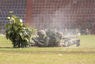 Personnel of the Central Reserve Police Force simulate a tactical operation as he taking position