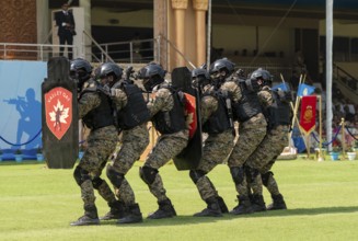Personnel of the Valley QAT unit of the Central Reserve Police Force advance in shield formation