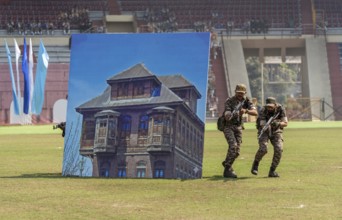 Personnel of the Central Reserve Police Force simulate an urban counter-terror operation, as they