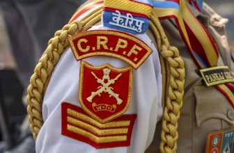 The ceremonial insignia and braided cord on the uniform of a personnel of the Central Reserve
