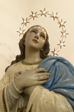 Wooden bust of St. Mary illuminated with a wreath of stars, Venice, Italy