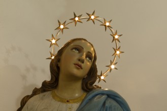 Wooden bust of St. Mary illuminated with a wreath of stars, Venice, Italy
