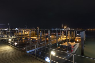 San Marco night-time boat dock, in the back the island of Saint Giorgio Maggiore, Venice, Veneto,