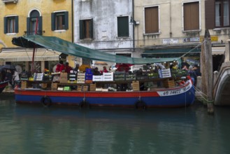 Selling fruit and vegetables on a boat, Venice, Veneto, Italy