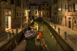 Evening gondola ride on a side canal in the Dorsoduro district, Venice, Veneto, Italy