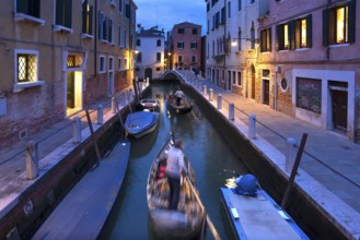 Gondolas in the evening in a side canal in the Dorsoduro district, Venice, Veneto, Italy