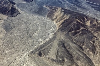 Wide mountain and desert area with recognizable Nazca lines in Peru, the geoglyphs and images in