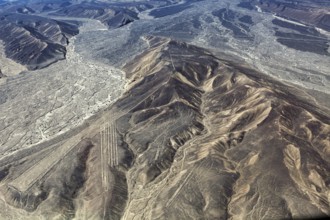 Aerial view shows mountainous desert landscape with clear geoglyph lines, the geoglyphs and images