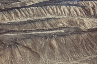 Aerial view of historic Nazca glyphs on the sandy hills of Peru, the geoglyphs and paintings in the