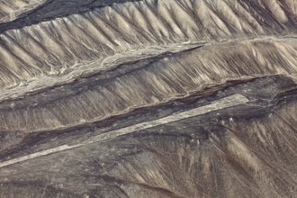 Aerial view of Nazca glyphs spanning sandy hills, the geoglyphs and paintings in the desert near