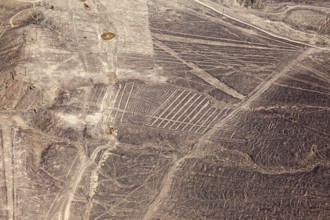 Nazca geoglyphs are visible on the dry surface landscape of the desert, the geoglyphs and drawings