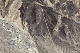 Aerial view of hills with recognizable geometric lines in the desert, the geoglyphs and images in