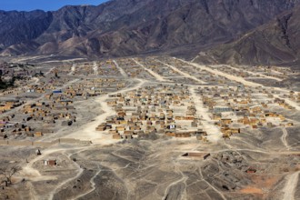 View of ordered settlements on the slopes of mountains in an arid region, the city of Nasca in Peru