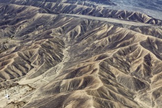 Barren range of hills with erosion-shaped structures in a dry environment, the desert landscape