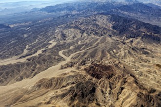 Extensive desert landscape with mountain ranges and sandy valleys from the air, The desert