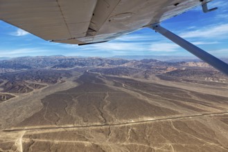 Desert landscape with a view from an airplane, mountains and a clear blue sky, The desert landscape