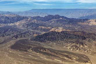 Barren mountain landscape in the desert with various shades of brown taken from above, The desert