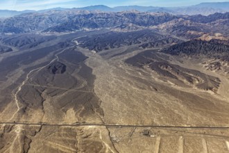 Extensive desert landscape with surrounding mountains photographed from a bird's eye view, The