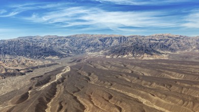 Landscape with dry desert area and mountain chain under blue sky, The desert landscape near Nasca