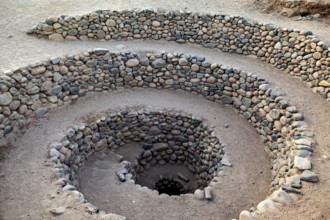 Stone spiral with evenly arranged layers of stone reaching into the earth, The ancient Nazca wells