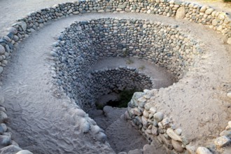Deep spiral of stones winding into the ground, The ancient Nazca wells (puquios) near Nazca, Peru