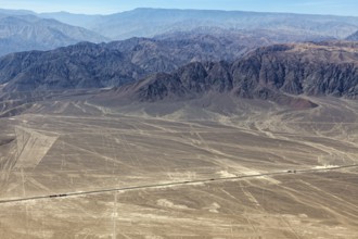 View of the Nazca Lines and surrounding mountains in a dry, barren landscape, the geoglyphs and