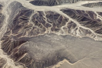 Erosion patterns and Nazca lines viewed from the air on a desert plateau landscape, the geoglyphs