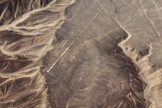 Desert landscape with recognizable lines and geoglyphs from the air, mountains surround the scene,