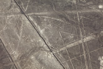 Geometric lines and patterns on a brown, dry desert surface, the geoglyphs and drawings in the