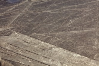 Nazca lines in a dry desert landscape with recognizable patterns, the geoglyphs and drawings in the