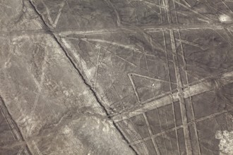 Aerial view of geometric lines on a barren desert landscape, the geoglyphs and images in the desert