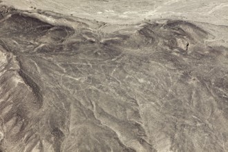 View of barren desert landscape with visible ancient line patterns, geoglyphs and drawings in the