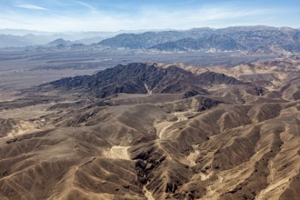 Breathtaking panorama of dry mountains in the desert under blue sky, the desert landscape near