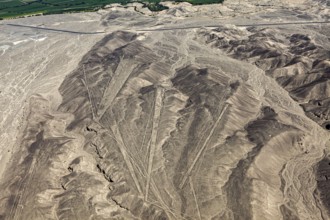Aerial view shows clear line patterns on dry mountain areas in the desert, the geoglyphs and images